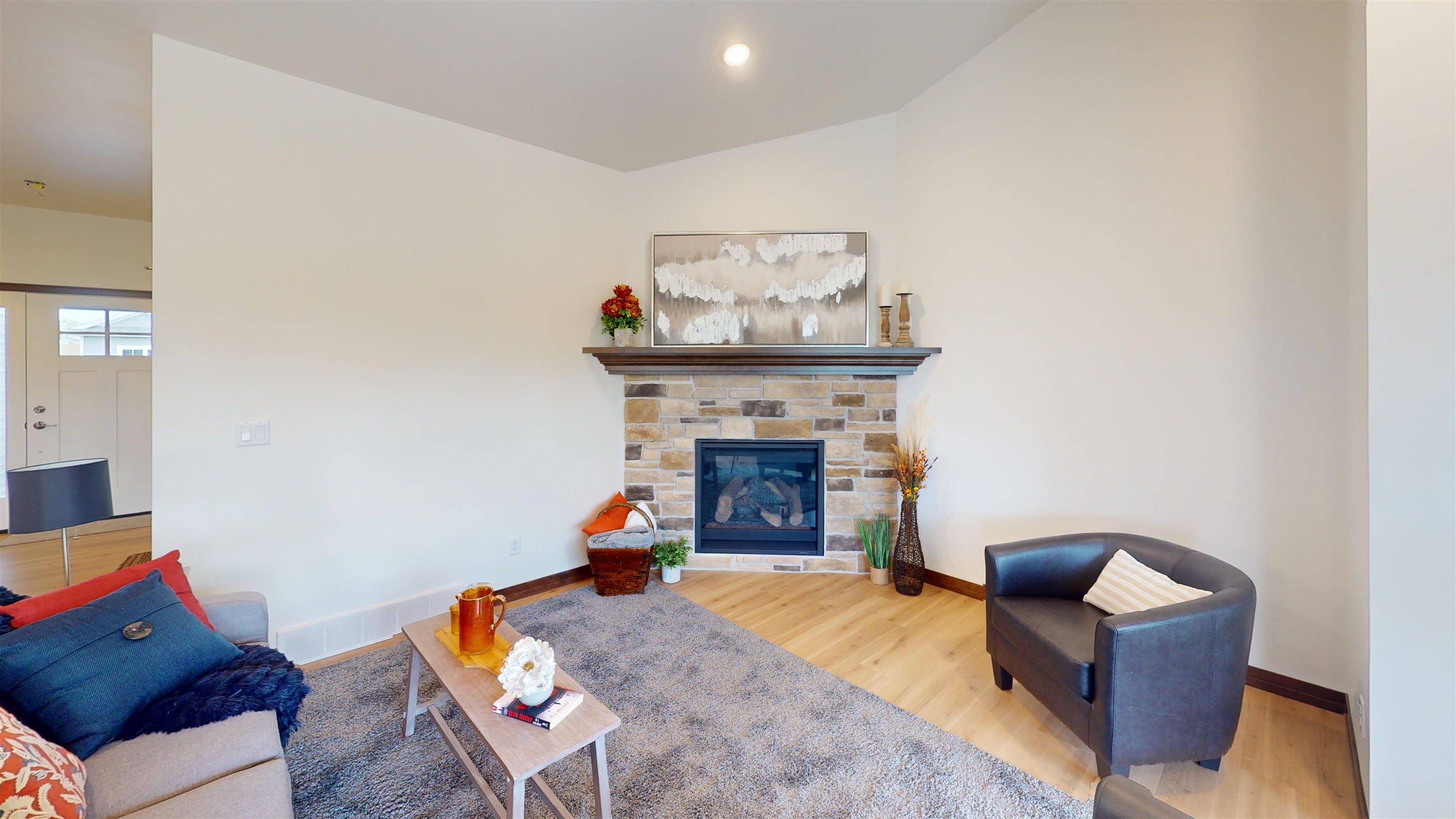 stone surround on gas fireplace.Flooring and stone color are different in this unit than photo