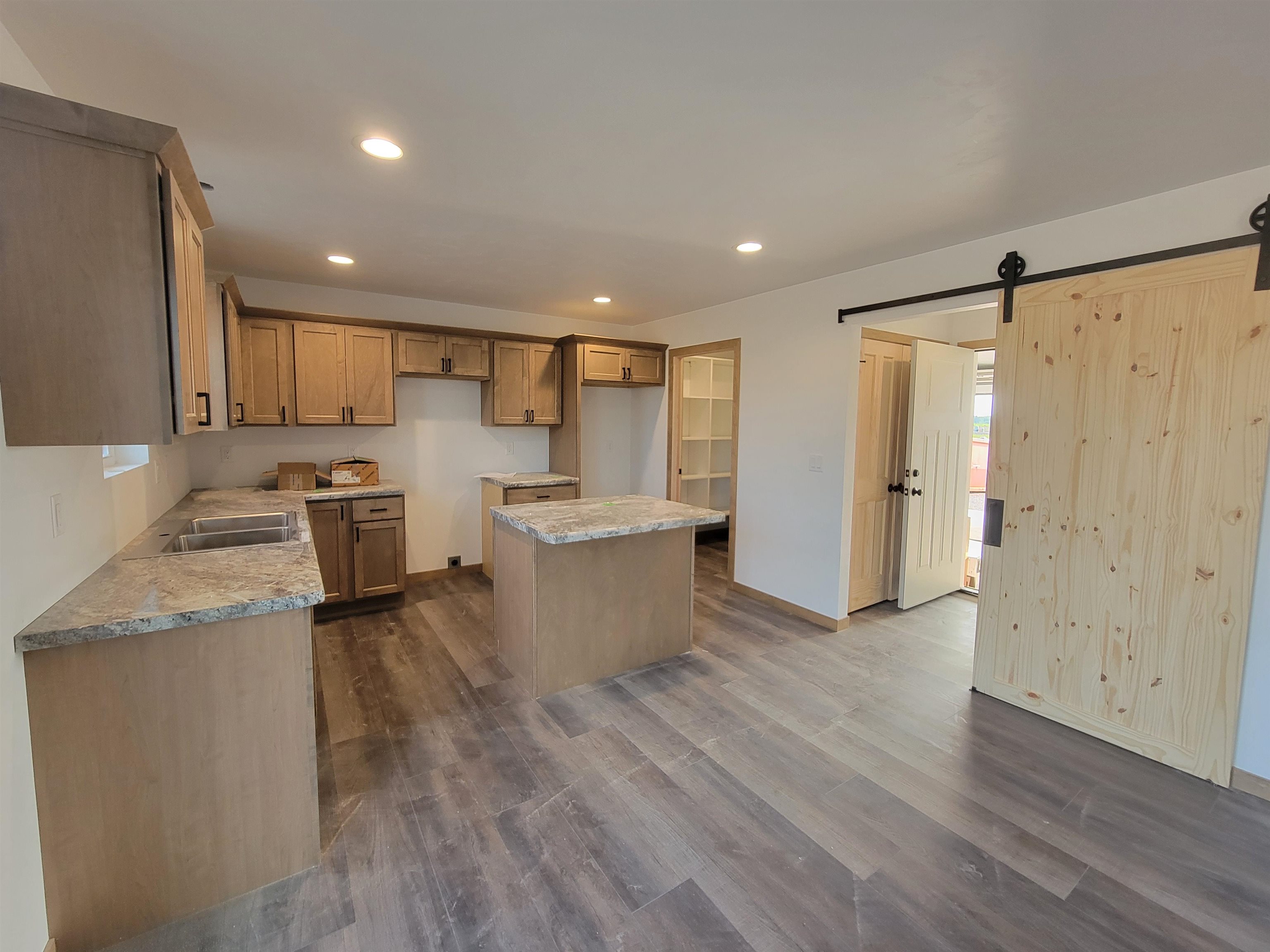 View from sliding patio doors into kitchen: Garage entrance/mudroom/laundry room, walk-in pantry