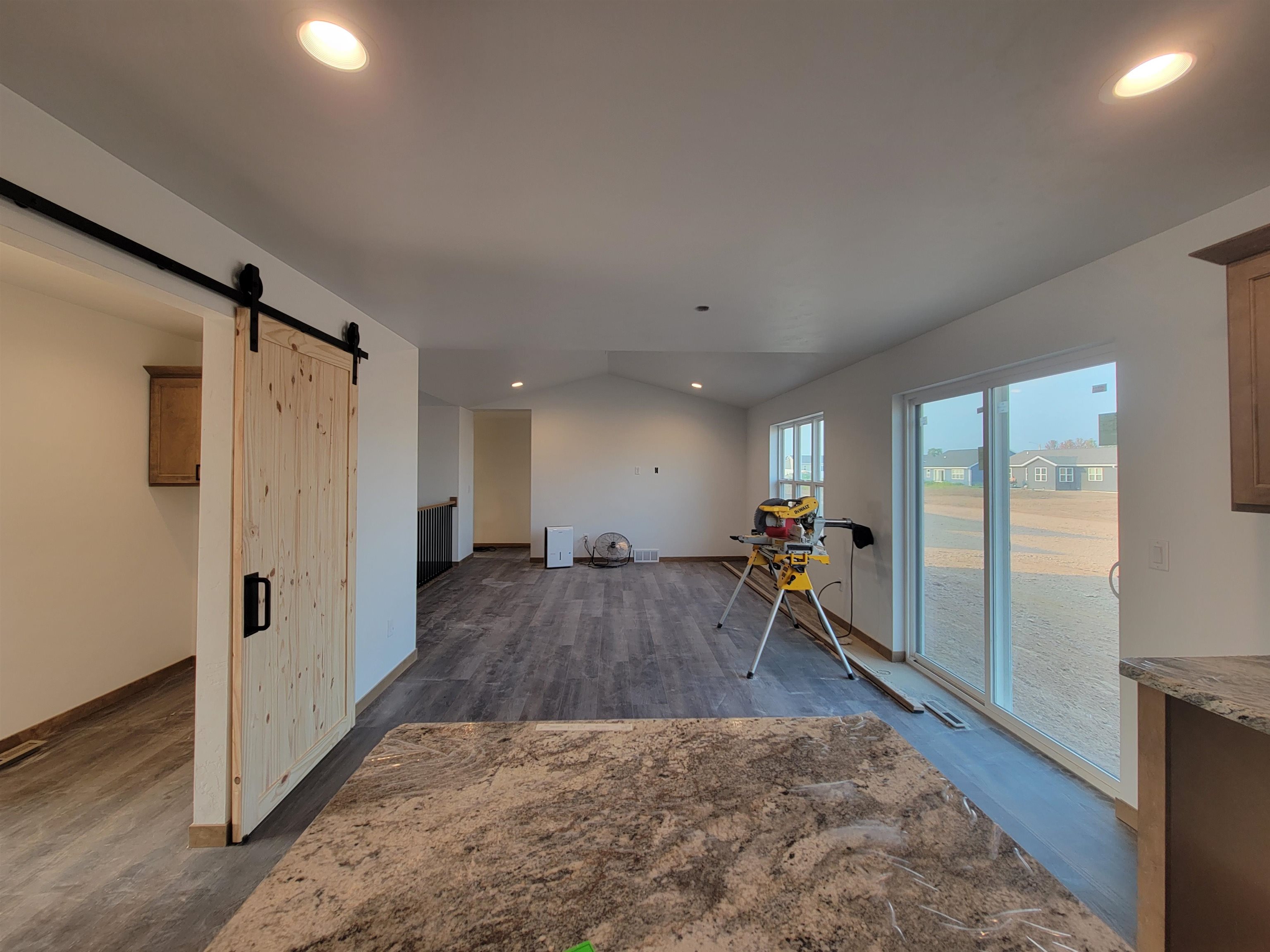 View from the kitchen over the dining room into the living room and the hallway to the 3 bedrooms