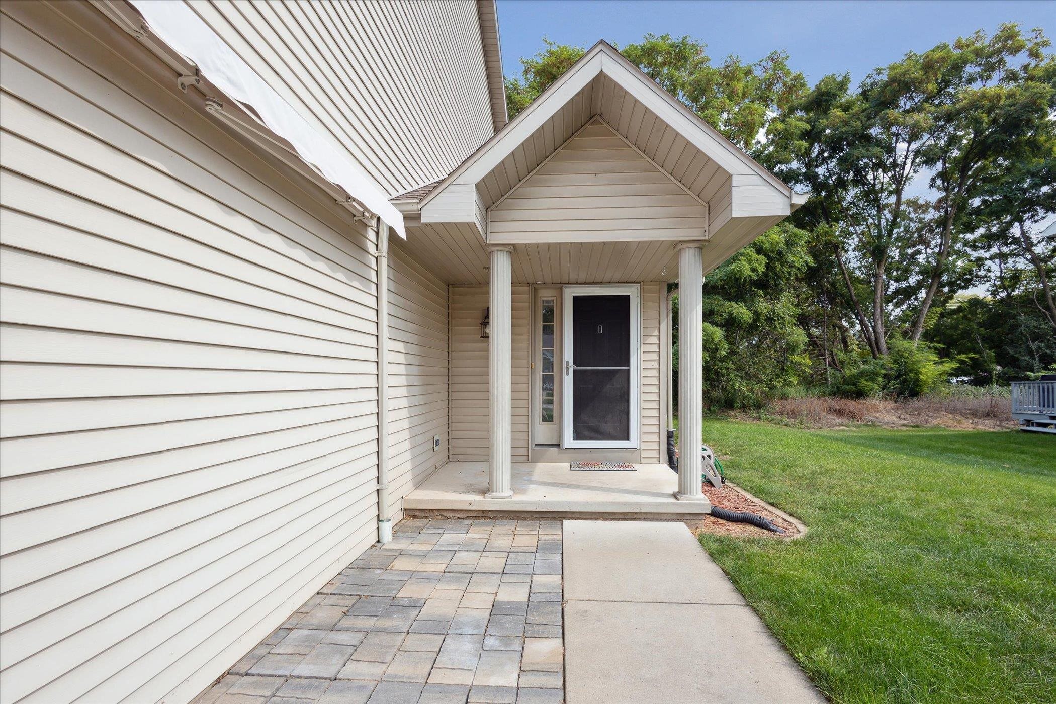 Relax under the roll out awning with a brick patio