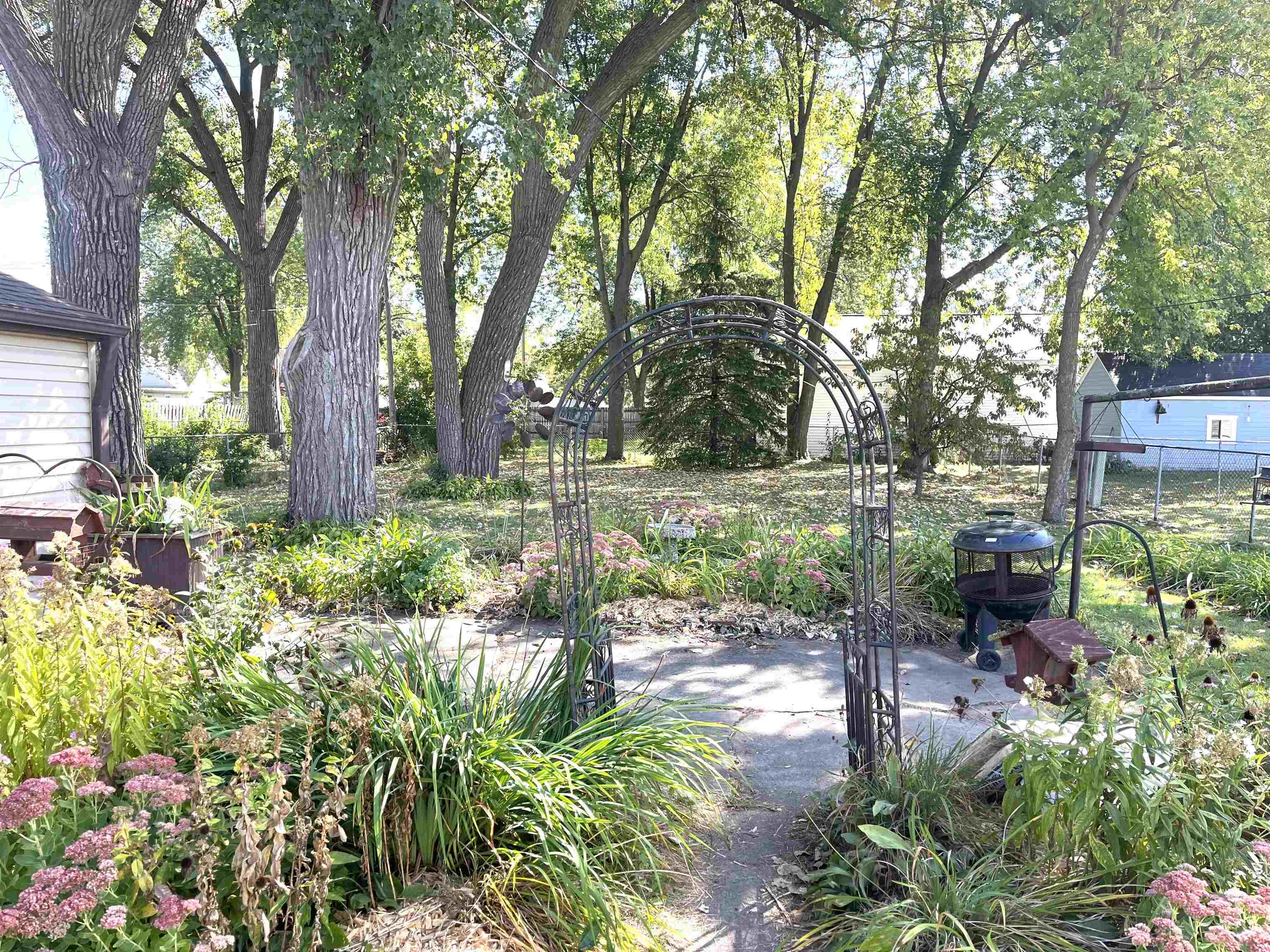 Plenty of room to play in for pets or children, with this fenced in back yard w/mature trees.