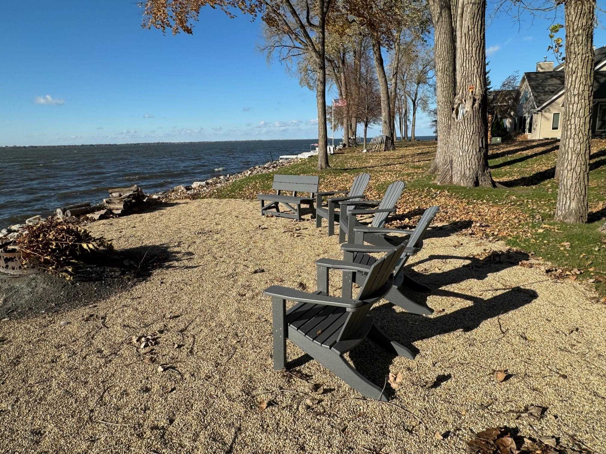 Common area with sand and Adirondack chairs