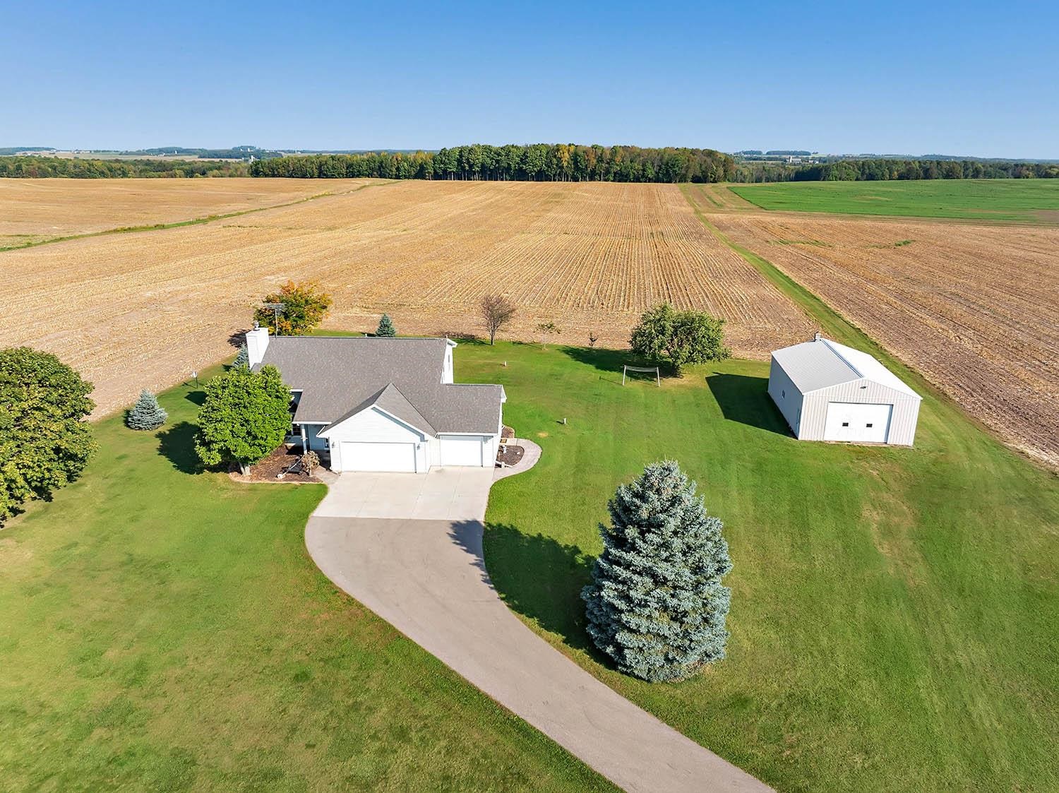 Picture shows home with attached garage and the 28x40 Building