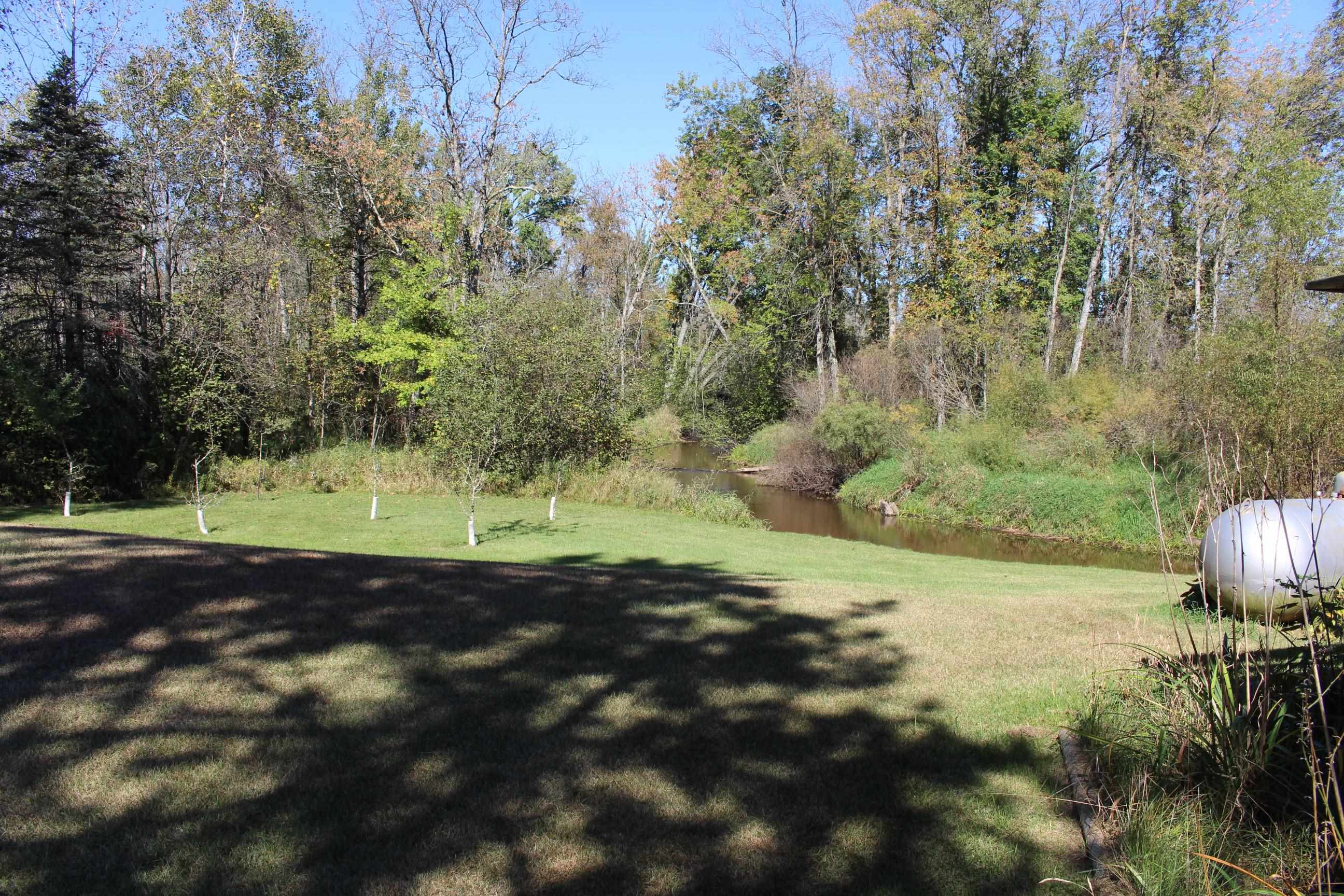 Ideal location for fly fishing brookies out the back door.  Fruit trees in foreground.