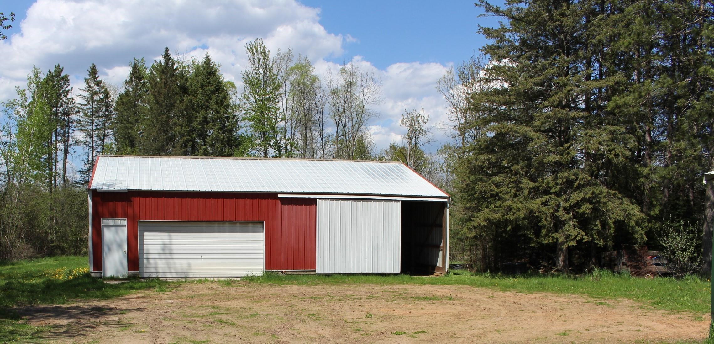 48'x36' pole building with 200 amp electrical panel, steel roof and concrete floor.  16'x7' door.