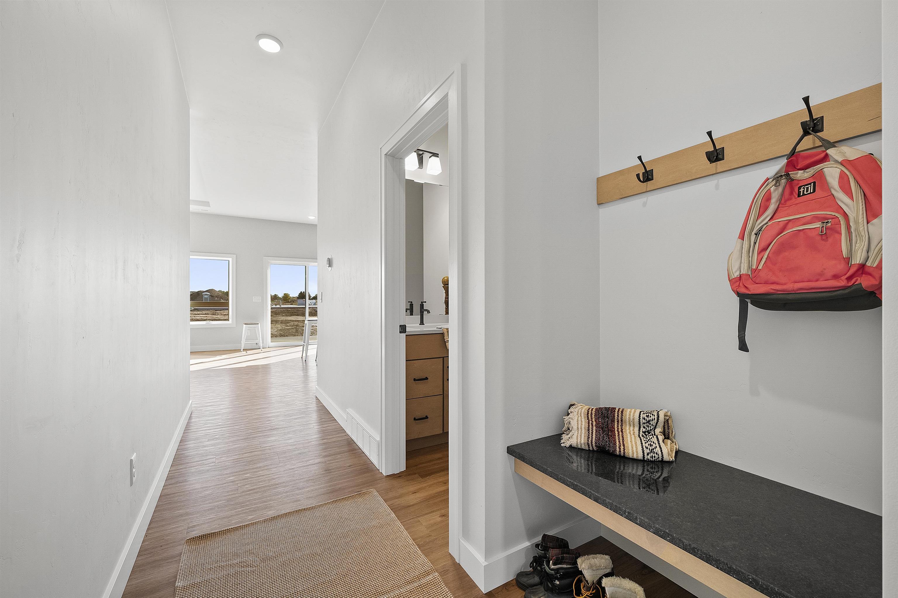 front hall showing shoe nook and powder bath