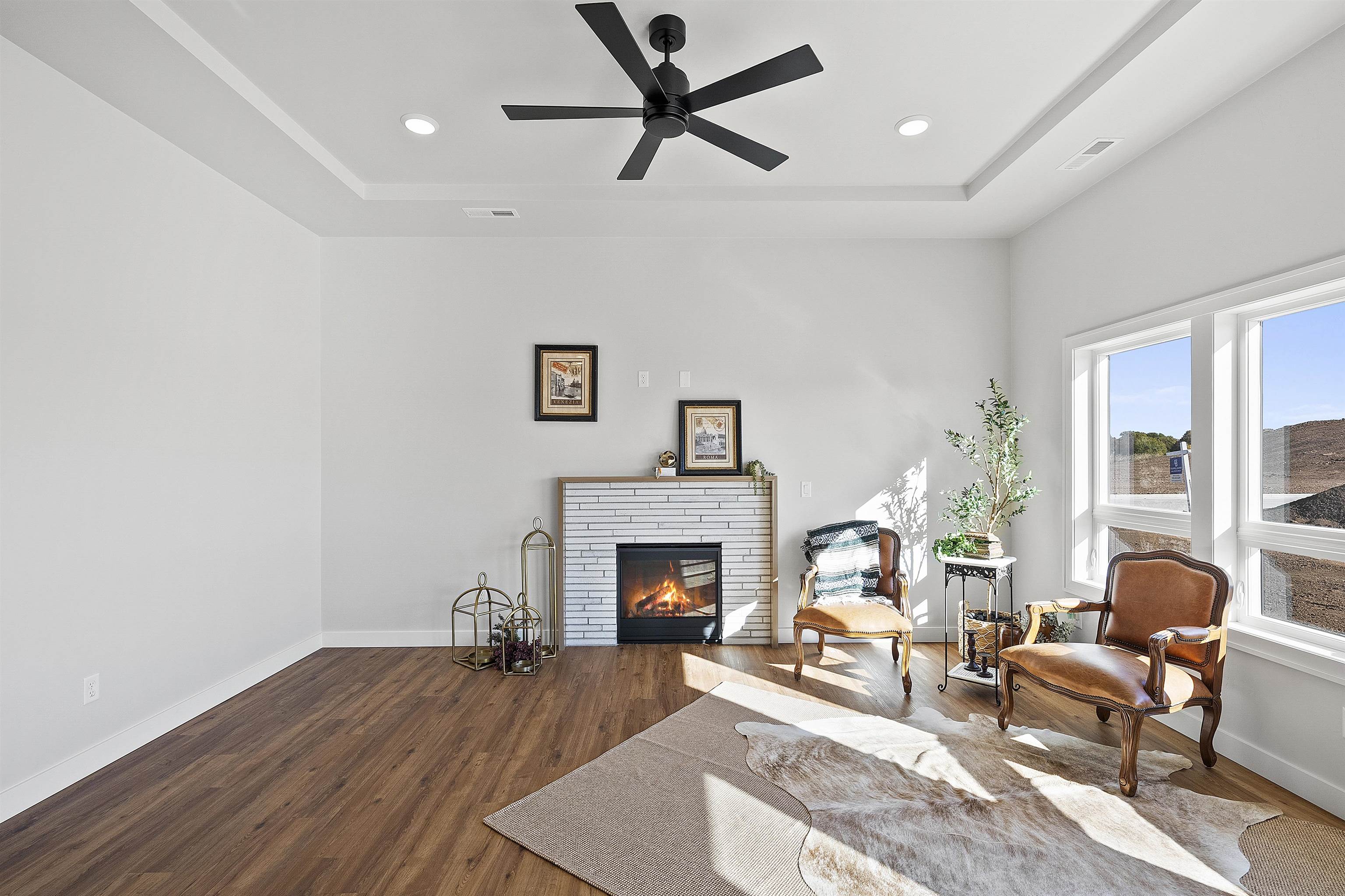 Living room with fireplace, tray ceiling and LVP flooring