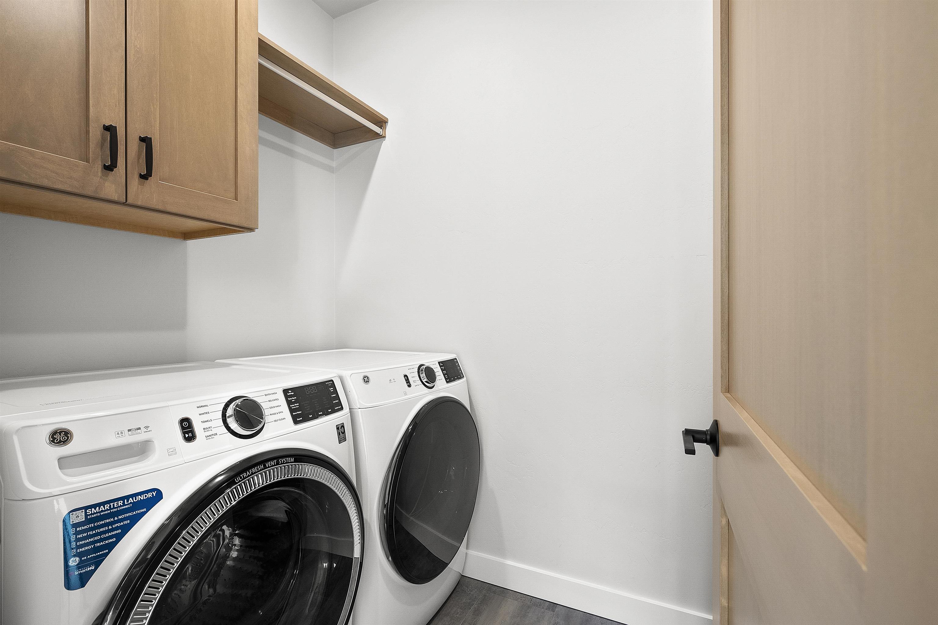 Laundry room wi/cabinets, clothes pole, folding counter & open basket storage. Washer/Dryer included